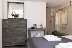 a bedroom with a dresser and a mirror at Ethos Retreat, Luxury Villas in Areopoli +22 photos