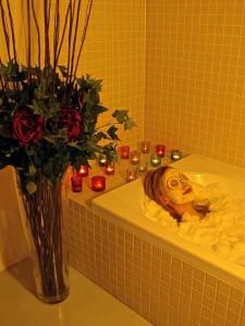 a vase of roses and candles in a bathroom at Chalet Broski - Luxury near St Martin De Bellville in Planvillard