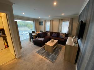 a living room with a couch and a table at Impala Apartment in Wick