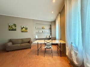 a living room with a table and a couch at Serravalle Castle Apartment in Serravalle