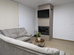 a living room with a couch and a fireplace at Kalea Elysivm in Alcalá del Júcar