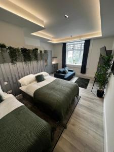a bedroom with two beds and a couch in it at ResiLets - Mood Studio 4 - Town centre studio room with en-suite in Bedlington +17 photos