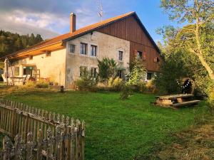 an old house with a fence in front of it at LaTerestone in Les Bayards
