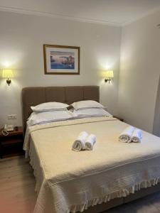 Postel nebo postele na pokoji v ubytování Hotel Vila Tina