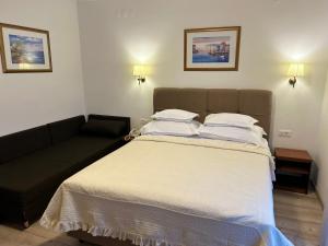 Postel nebo postele na pokoji v ubytování Hotel Vila Tina