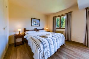 a bedroom with a large bed and a window at Apartur Catedral in San Carlos de Bariloche