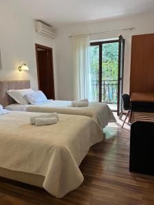 Postel nebo postele na pokoji v ubytování Hotel Vila Tina