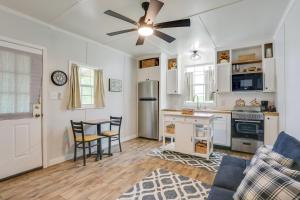 a kitchen with white cabinets and a ceiling fan at Near Parks and Lakes Pet-Friendly Winnie Cottage in Winnie