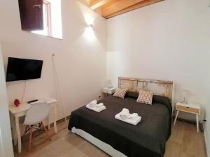 Postel nebo postele na pokoji v ubytování Le Nuvole di Ortigia