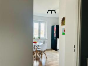 a kitchen with a table and chairs and a refrigerator at Rodzinna Przystań in Wałbrzych +15 photos