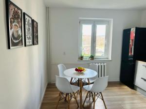 a dining room with a white table and chairs at Rodzinna Przystań in Wałbrzych