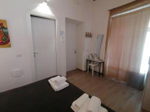 Postel nebo postele na pokoji v ubytování Le Nuvole di Ortigia