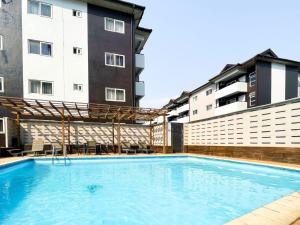 アクラにあるSafari Luxury Apartmentの2棟の建物の前にあるスイミングプール