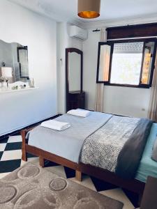a bedroom with a bed and a mirror and a sink at Blue Pearl city in Chefchaouene
