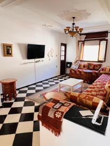 a living room with a checkered floor at Blue Pearl city in Chefchaouene