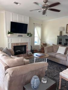 a living room with two couches and a fireplace at 3 Bed, 2 and a half bath Gorgeous Coastal Home 1 block from beach! in Long Beach