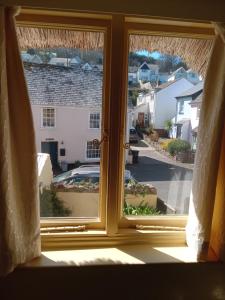 a window with a view of a street at Dolphin Cottage 50m from Shaldon Beach! in Shaldon