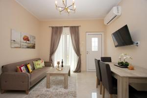 a living room with a couch and a table at Skyway Comfort Residences in Spáta