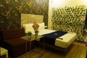 Voodi või voodid majutusasutuse Hotel AlpineglO Yercaud toas