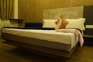 Voodi või voodid majutusasutuse Hotel AlpineglO Yercaud toas