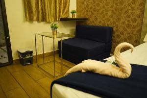 Voodi või voodid majutusasutuse Hotel AlpineglO Yercaud toas
