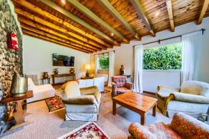 a living room with furniture and a stone wall at Apartur Catedral in San Carlos de Bariloche