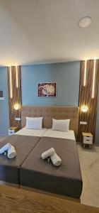 a bedroom with two beds with towels on them at Sidari Escapes By The Beach in Sidari
