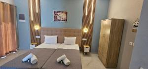 a bedroom with a bed with two pillows on it at Sidari Escapes By The Beach in Sidari