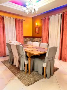 a dining room with a wooden table and chairs at Meru Havens in Arusha