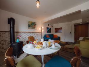 a living room with a table and a stove at eARTh studios GallerySuite in Nelson