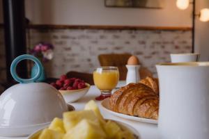 a table with a tea kettle and a plate of food at eARTh studios GallerySuite in Nelson +42 photos