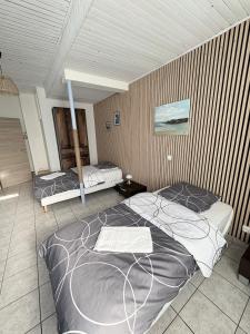 a bedroom with two beds in a room at Horse House Calm and Nature near motorway and Basel in Kembs +23 photos