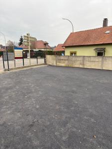 an empty parking lot in front of a building at Horse House Calm and Nature near motorway and Basel in Kembs