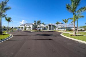 an empty street with houses and palm trees at Serene lakefront pool home in Lorraine Lakes - Coral Paradise in Bradenton