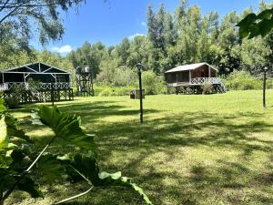 a park with two pavilions and two houses at Las Luciérnagas del Delta 2 in Tigre