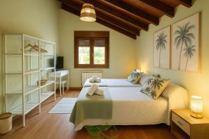 Postel nebo postele na pokoji v ubytování Casa Vacacional Maldivas de Llanes