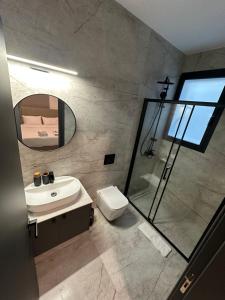 a bathroom with a shower and a sink and a mirror at Lux Level 4 Penthouse Tower 206 in Nicosia +44 photos