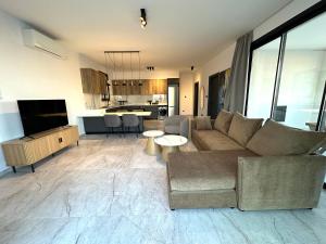 a living room with a couch and a kitchen at Lux Level 4 Penthouse Tower 206 in Nicosia