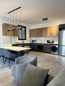 a kitchen with a table and some chairs and a table and a kitchen at Lux Level 4 Penthouse Tower 206 in Nicosia