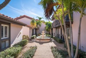 a courtyard with a fountain in front of a house at Gorgeous Lido Key condo - 6 minute walk to beach in Sarasota