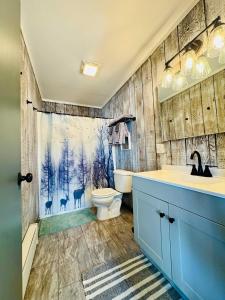 a bathroom with a sink and a toilet and a shower at Cozy Mountain View Condo at Powderhorn Mountain in Bessemer +9 photos