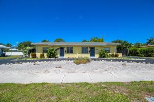 a yellow house with a driveway in front of it at 1BR Venice home with private beach access - Golden Beach Haven in Venice