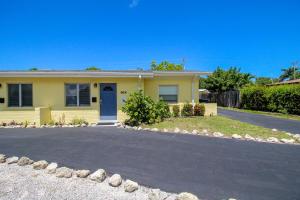 a yellow house with a driveway in front of it at 1BR Venice home with private beach access - Golden Beach Haven in Venice