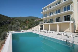 a large swimming pool in front of a building at Apartments Marovic in Herceg-Novi