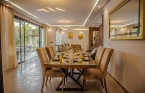 a dining room with a wooden table and chairs at AD Villa in Marrakesh