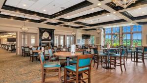 a restaurant with tables and chairs and a clock at Lakefront 3rd floor condo at River Strand Golf and Country Club in Bradenton