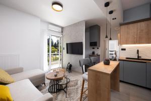 a kitchen and living room with a couch and a table at Glyfada Luxury Suite in Athens +18 photos