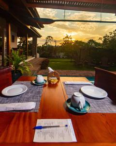a wooden table with plates of food on it at Boutique Hotel Carpe Diem in Paraty