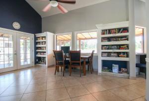 a dining room with a table and chairs and bookshelves at Resort-style living near IMG, Anna Maria Island, and Bradenton Beach in Bradenton