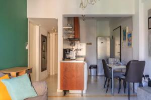 a kitchen and living room with a table and chairs at AIOLOS Glyfada LUX Escape suite 6 in Athens